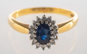 An 18ct gold sapphire and diamond cluster ring,