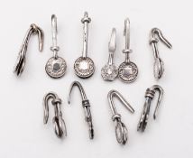 A mixed group of silver and silver plated napkin clips of similar design; various dates and makers,