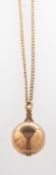 A Masonic ball pendant with chain, the Masonic ball is hinged and opens to one side,