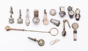 A mixed group of base metal and silver gilt napkin clips,