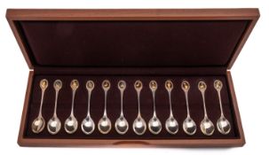 A cased set of twelve RSPB parcel gilt silver tea spoons by John Pinches, London 1976,