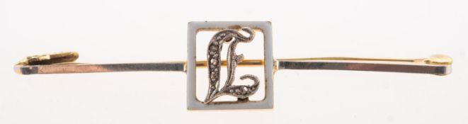 A diamond and enamel initial brooch,