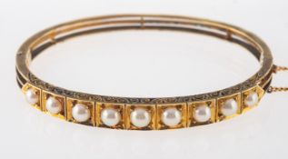 A Victorian gilt pearl bangle,