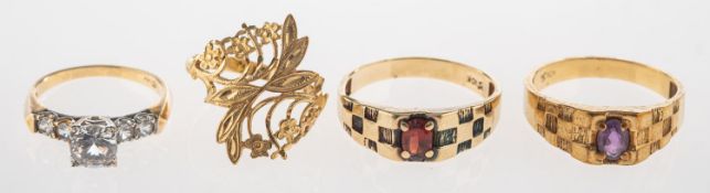 A mixed group of jewellery, including a ring set with an oval-cut red stone,