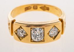 An antique three stone ring, square set to the centre with a cushion-cut diamond, diamond approx. 0.