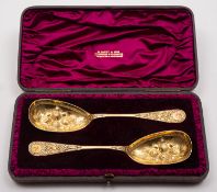A cased pair of Victorian silver gilt berry spoons by Martin, Hall & Co, London 1871, retailed by W.