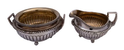 A pair of George III cast silver milk and sugar bowl by William Burwash & Richard Sibley,
