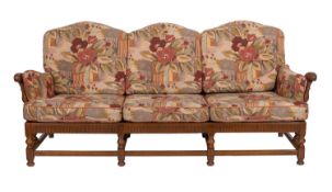 An elm and upholstered suite, by Ercol,