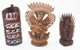 A group of carved wooden artifacts comprising two Balinese figures of Vishnu,