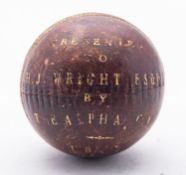 A presentation cricket ball inscribed 'P