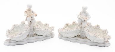 A pair of Meissen figural sweetmeat bask