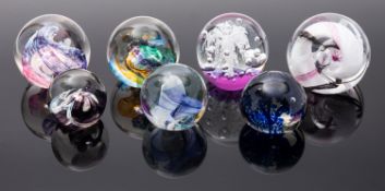 Seven glass paperweights comprising two