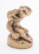 A Japanese porcelain model of a seated monkey with a toad on his back, 8cm high, Meiji.