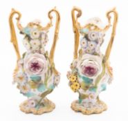 A pair of Coalbrookdale porcelain flower encrusted vases of slender form with rustic handles,
