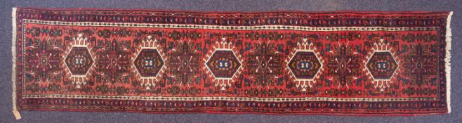A Karaja runner, the rose field with a row of hooked hexagonal and cruciform medallions,