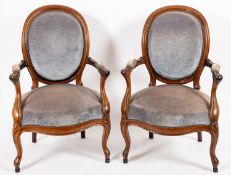 A pair of walnut and upholstered open elbow chairs in Louis VX style,