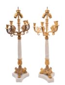 A pair of marble and gilt metal mounted five light candelabra in 'Regency-Empire' taste,