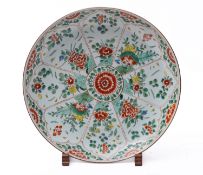 A Chinese famille verte charger, Kangxi painted with lotus shaped panels of flowering shrubs,