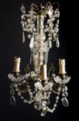 A gilt metal, moulded and cut glass four light chandelier in early 19th century taste,