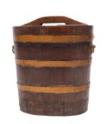 A metal bound oak vessel, possibly previously a churn, late 19th century; of oval section,