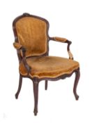 A carved hardwood and upholstered library elbow chair in George II style,