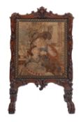 An early Victorian carved rosewood and embroidered fire screen,