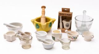 A collection of porcelain and glass mortars and pestles, 20th century; of varying pattern and size,