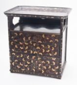 A Japanese black and gold lacquer cosmetic cabinet,