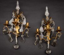 A pair of gilt brass and glass adorned three light wall appliques, in Louis XV taste,