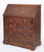 A Victorian carved oak bureau in Baroque taste,