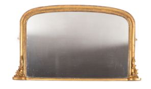 A Victorian giltwood framed overmantel mirror, circa 1860; of shallow arched rectangular form,