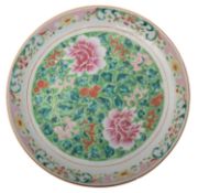 A Chinese porcelain charger enamelled in the famille rose palette with peony,