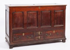 An oak mule chest, early 18th Century; the rectangular hinged top with moulded edges,