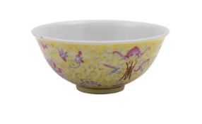 A Chinese yellow-ground famille rose bowl enamelled with bats, shou symbols and scrolling peony,