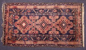 A Kuba rug, the shaded field with triple stepped lozenge and geometric medallions,