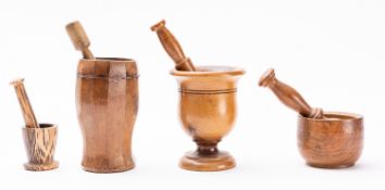 Four turned treen mortars with pestles,