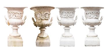 A set of four Victorian painted cast iron twin handled garden urns,