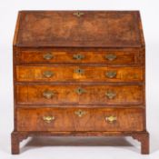 A George II walnut and crosbanded walnut bureau, mid 18th Century.