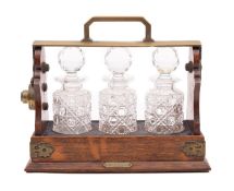 A Victorian oak and brass mounted Betjemann's Patent tantalus,