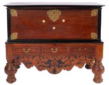 A Sri Lankan teak and ebony chest on stand in 17th Century taste, the hinged top with ebony border,