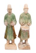 A pair of Chinese Tang pottery musicians modelled as a standing trumpeter and a drummer on stepped