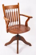 An Edwardian oak swivel desk chair,