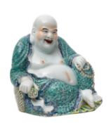 A Chinese porcelain figure of Hotei the portly and jovial God in seated position holding a string