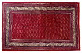 An Arak carpet, the wine field with an all over boteh design,