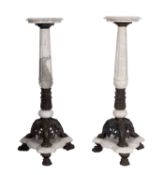 A pair of marble and metal mounted pedestal stands,