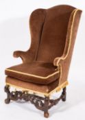 A William & Mary oak and upholstered wingback armchair,