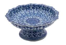 A Chinese blue and white footed dish, Qing Dynasty with foliate barbed rim,
