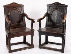 A pair of oak Wainscot elbow chairs, one circa 1700, the other dated 1909;