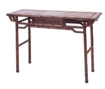 A Chinese carved and stained hardwood side table,