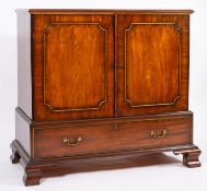 A George III mahogany press cupboard, late 18th century; the top with moulded edges,
